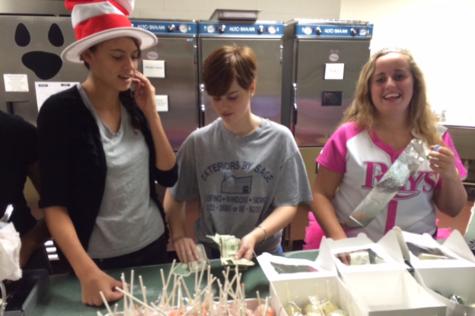 Left to right: Juniors Annie Brey, Hannah Sage and Grace Horn prepare cake pops for the bake sale.