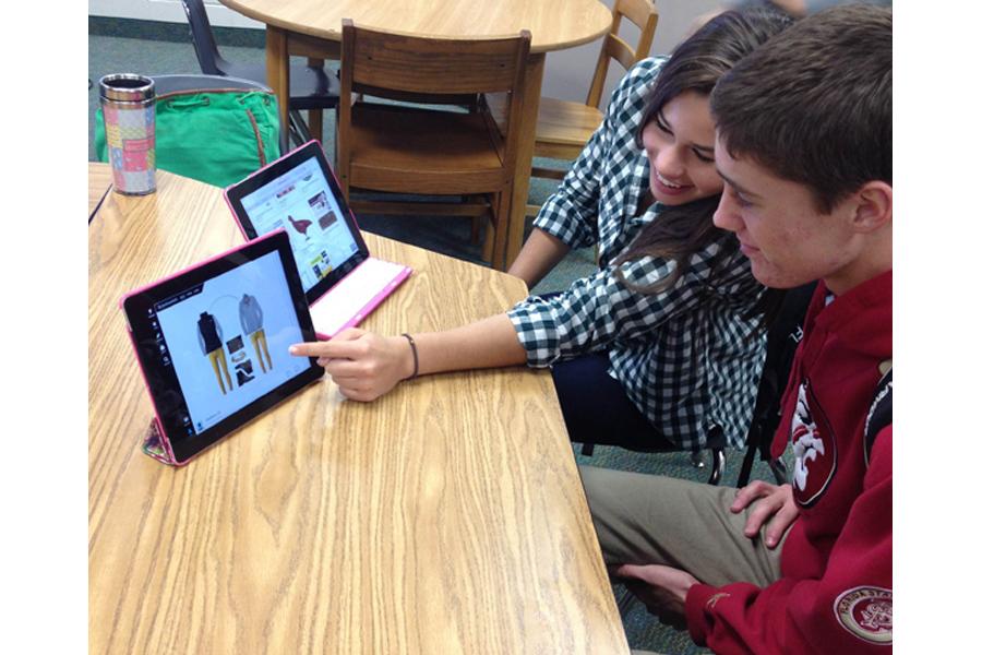 Lane Barnes, junior shows fellow class mate Bobby Harrison how to use Polyvore. 