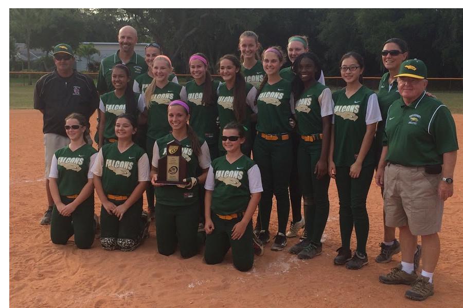 The+softball+team+poses+with+their+trophy+after+the+game