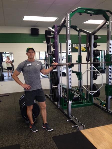 Mr. Shultes stands by his weights, in his new office. 