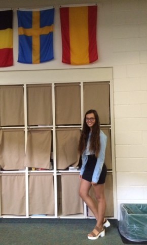 Junior Laura Rodriguez poses in front of the Spanish flag.
