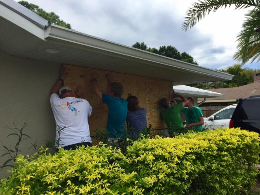 Carter Beckstein boards up windows with family and friends to prepare for Irmas arrival.