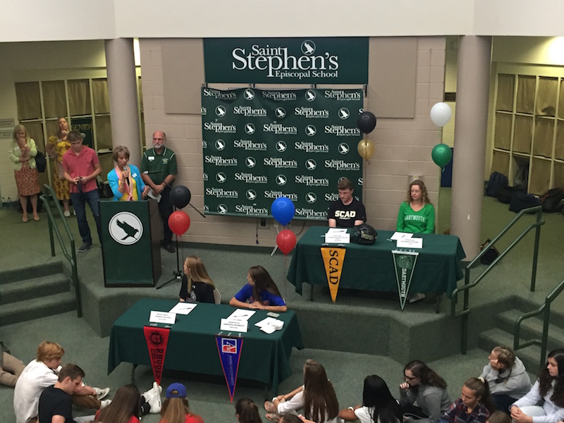 Four senior-athletes signed their lives away to the colleges of their choice during assembly Wednesday. 