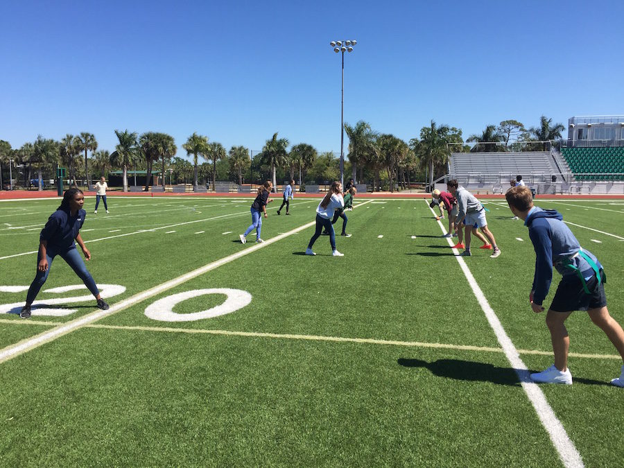 During lunch break, Powder Puff players from all grades are out on the stadium prepping for next Fridays big game.  Here, you can see senior boys running an offense to ready the girls defensive tactics. 