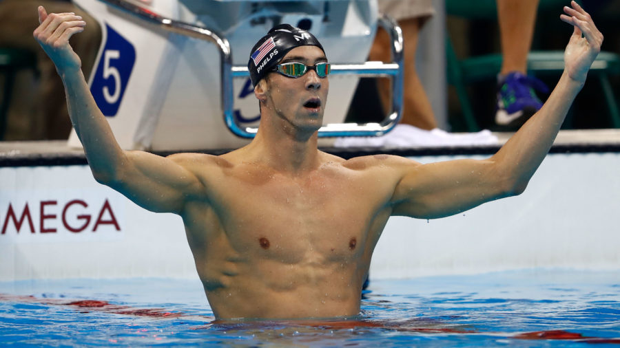 Michael Phelps celebrates winning his 20th gold medal after a razor-thin victory in the mens 200-meter butterfly at Rios Summer Olympics on Tuesday.