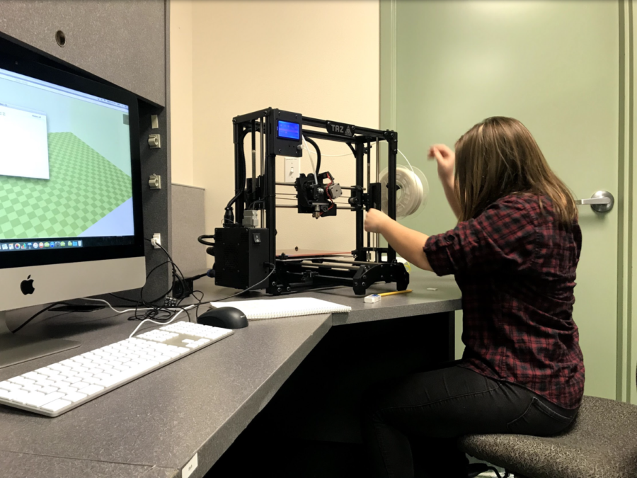 Senior Amy Woodworth working on her independent study in 3D printing 