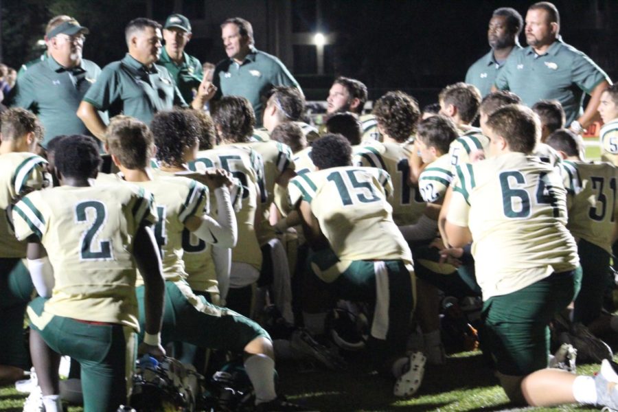 Coach Creneti speaks to the team after their victory against Cambridge Christian 