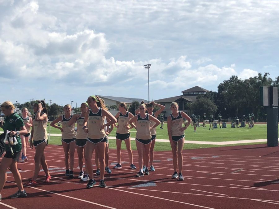 The girls cross country team preps for the meet.  