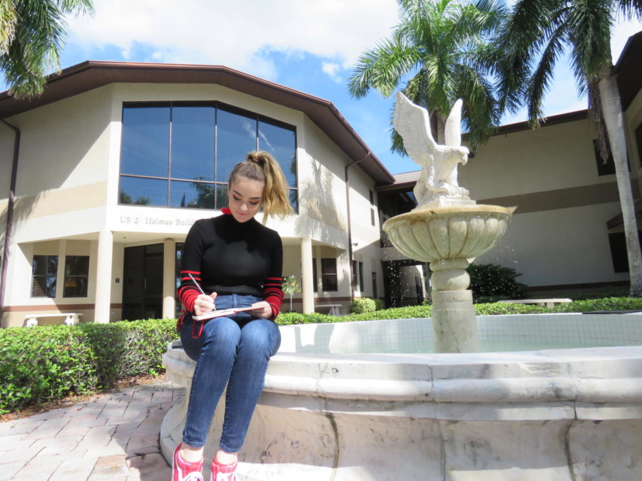 Junior, Meg LaFollette, does pencil sketches by the iconic falcon fountain in the courtyard.