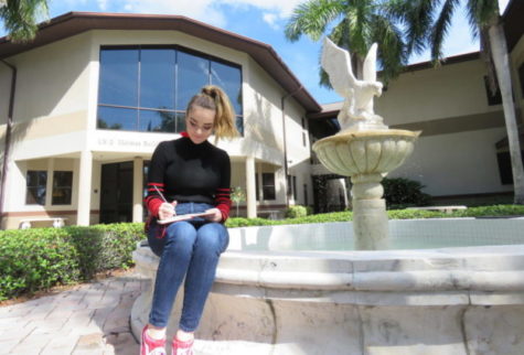 Junior, Meg LaFollette, does pencil sketches by the iconic falcon fountain in the courtyard.