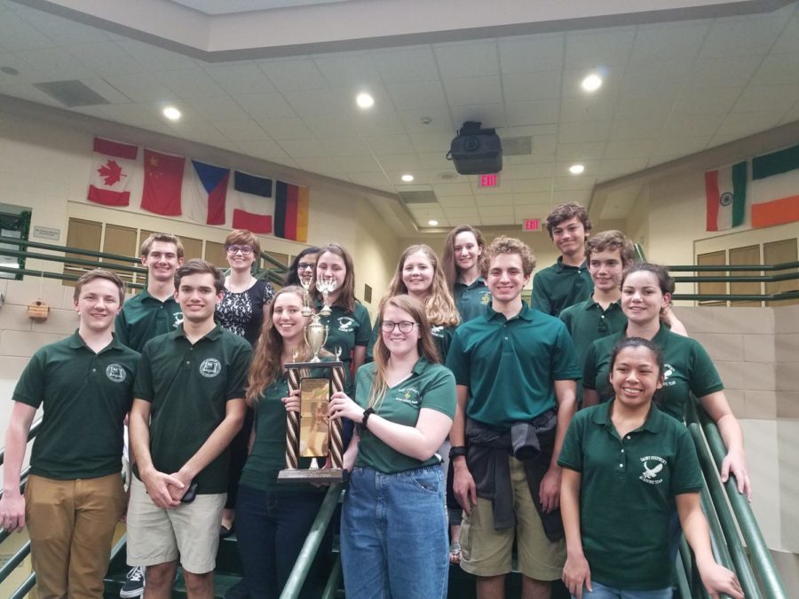 The 2018-19 academic team poses for a group photo, proudly presenting their trophy.