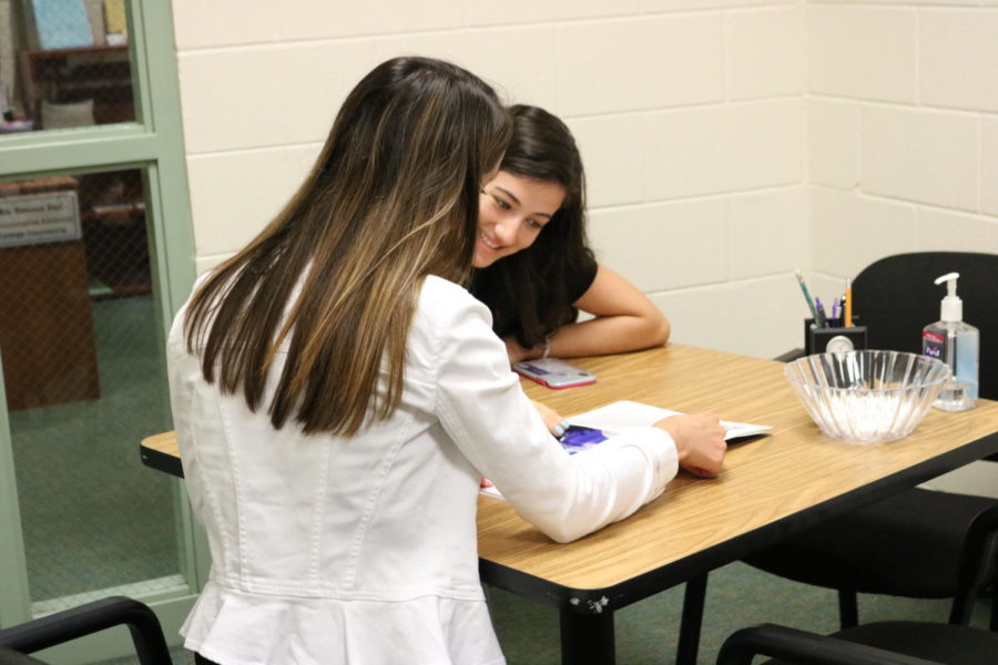 College Counselor Mrs. Codie Moss conferences with soon-to-be senior Alana Brader. 