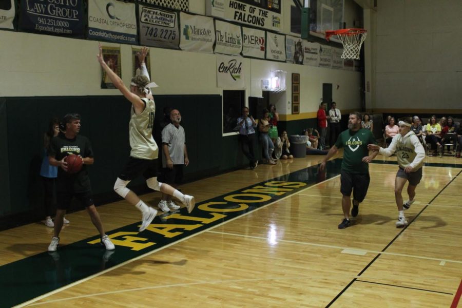 Senior Wyatt Sevin, heavily guards Mr. Santa Maria in an attempt to deflect the ball.