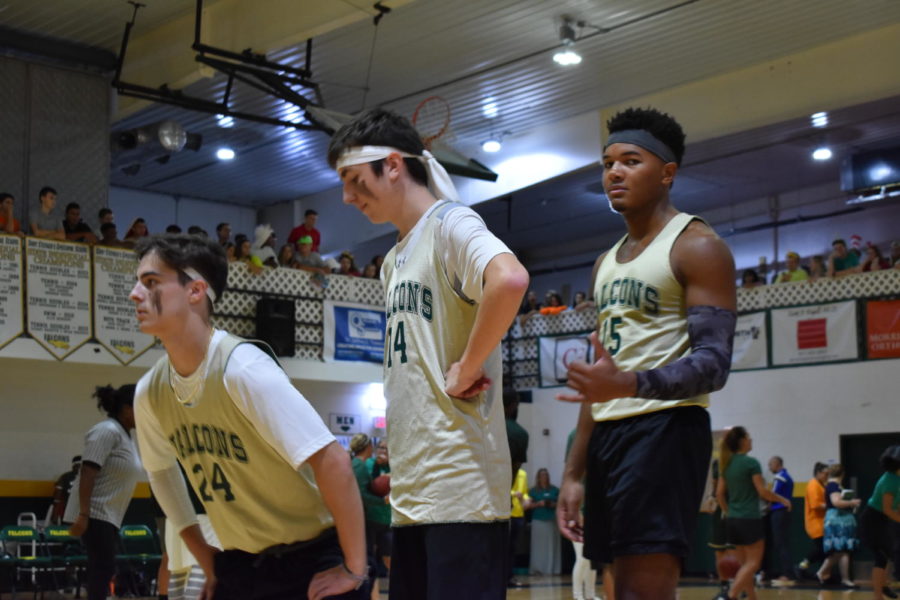 Seniors Julian Sedillo, Caden Milburn, and Tyler Wade warm up for the game.