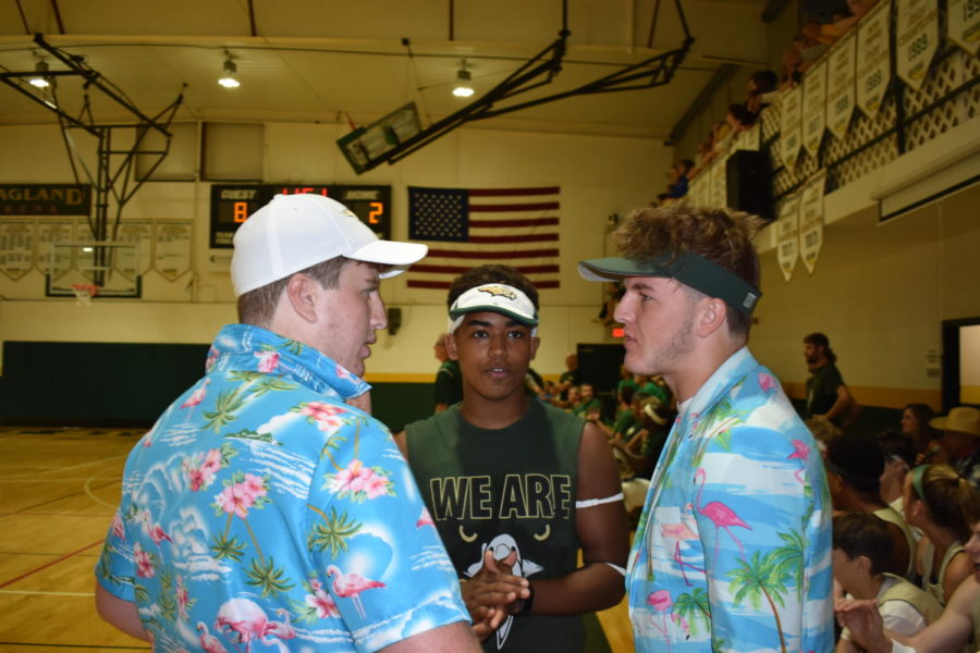 Senior coaches Alex Sket, Tristan Brown, and Cam Vining talk strategy and substitutions for the first string players. 