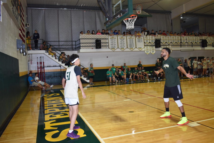 Junior Cheng Zhang looks to pass in the ball, yet is guarded by Varsity Girls Basketball Coach David Gaulman.