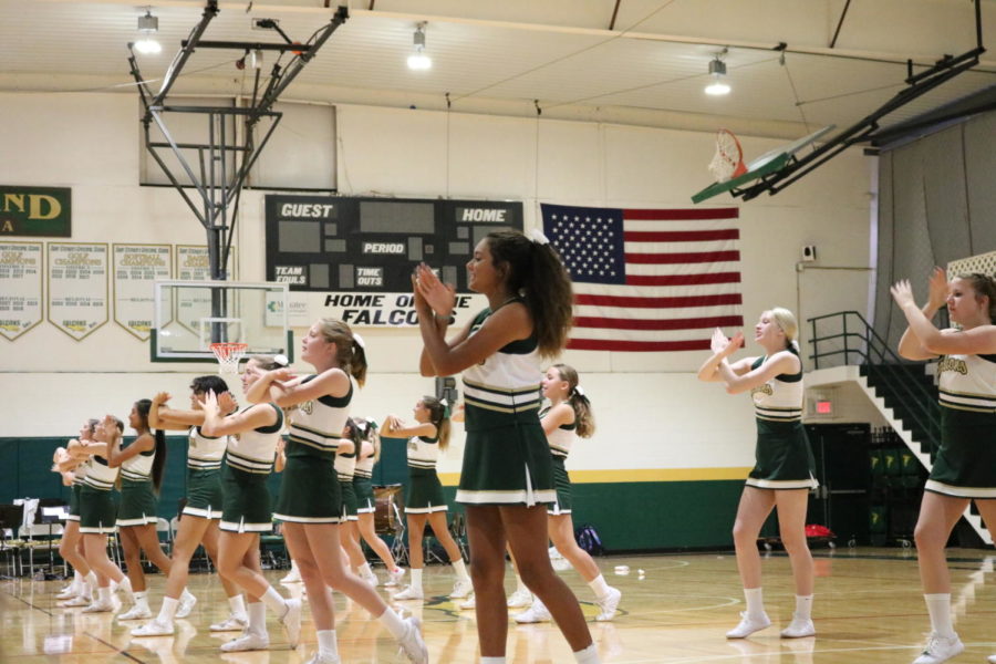 The cheerleaders perform their go Falcons cheer, as the rest of the school repeated it back to them.