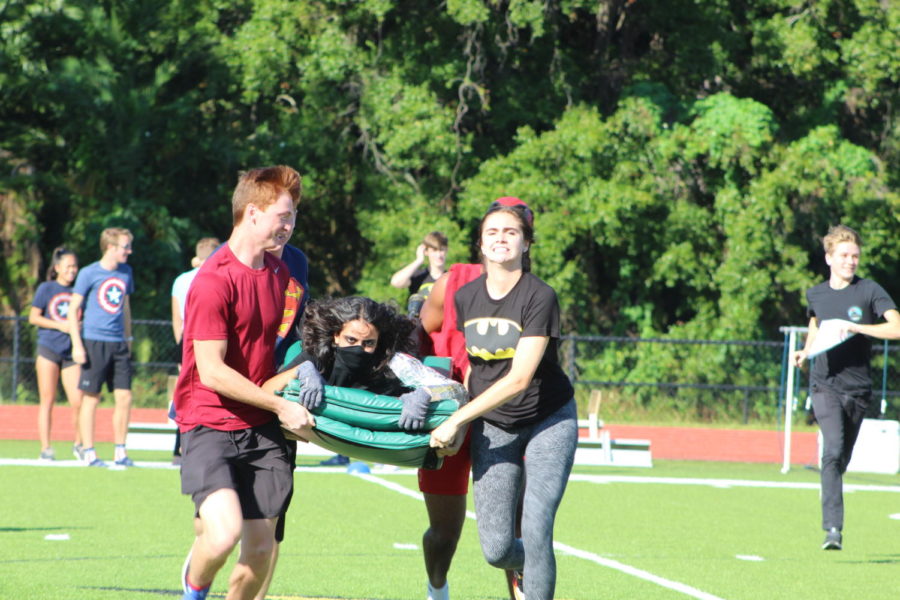 Senior Gabby Crenetti struggles to balance while being carried across the feild.