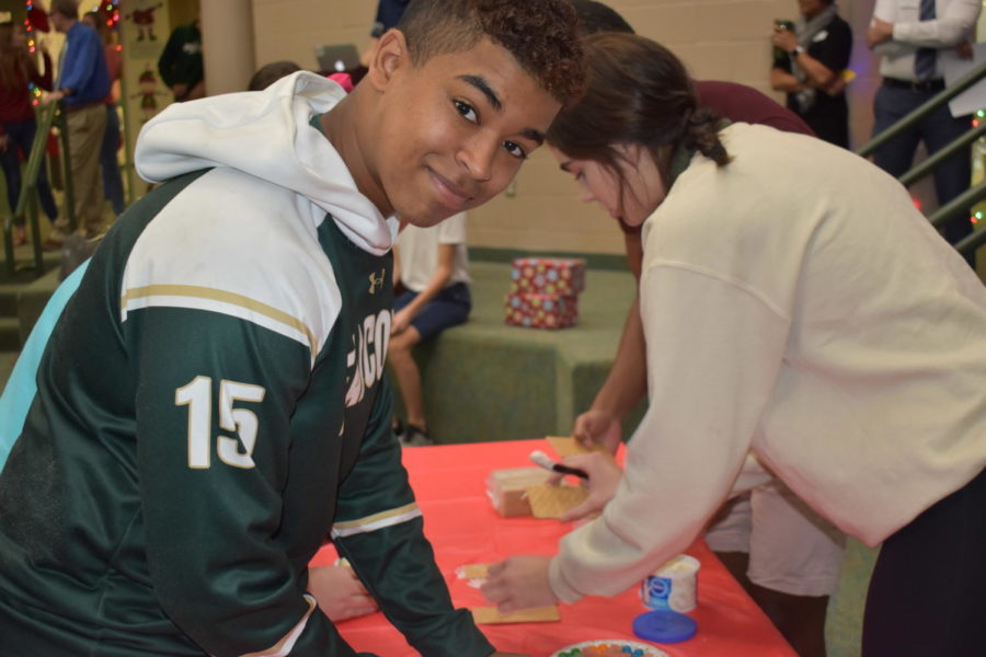 Senior Trystan Brown smiles for the camera while helping to build the seniors ginger mansion.