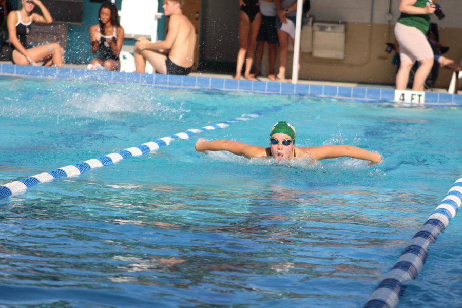Senior swim team captain Anika Kennedy swims fast in her leg of the 200 medley relay: the 50 fly. 