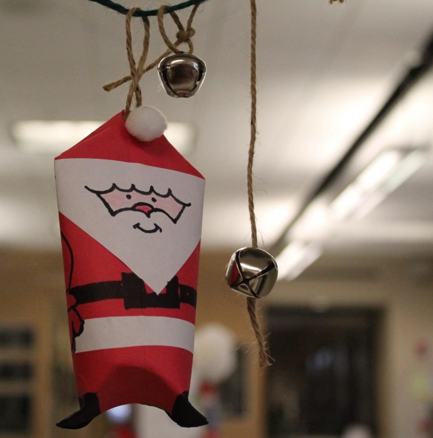 Mrs. DeZiel is getting festive by making a paper Santa and hanging it up on her door!