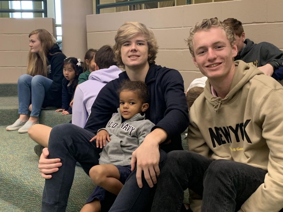 Seniors Wyatt Sevin and Ty Barker smile with their Fledgling Falcon friend.