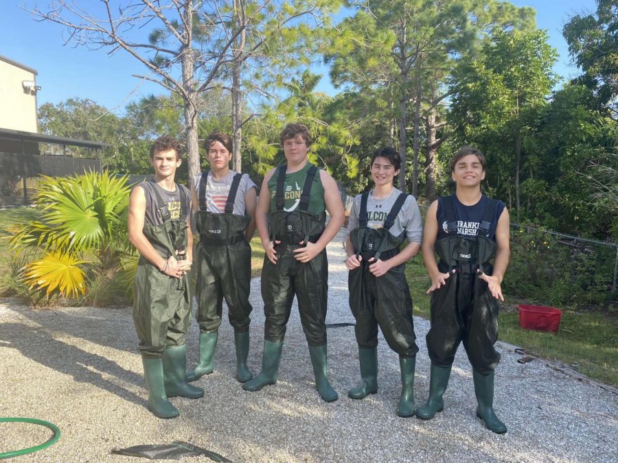 The boys pose in their waders as they prepare to collect samples of hermit crabs at the entrance to the Manatee River.