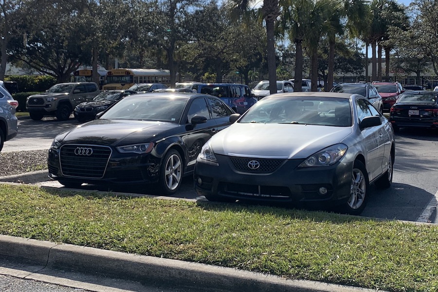 My "high-performance machine," as my boss Victor calls it, parked next to a JUNIOR in the SENIOR lot.