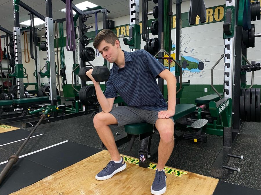 Photo of Jackson Nealis 23 doing a concentration curl (Joshua Sket)