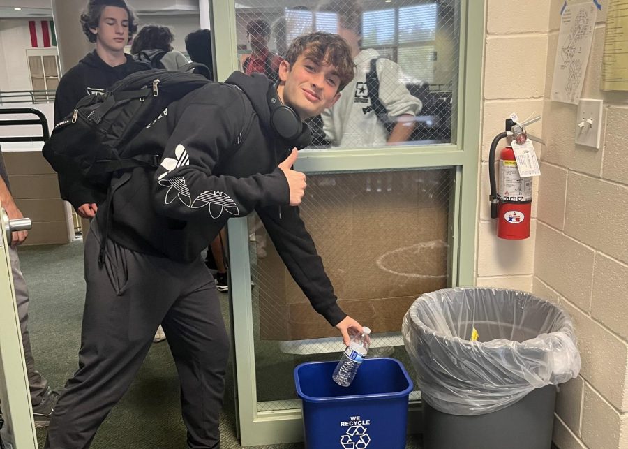 A Saint Stephens Student, Danny Dodaj, recycles his water bottle. 