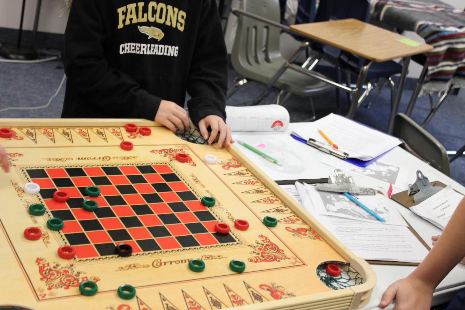 Students enjoy a game of checkers, one of the possible games available to explore during the event. 