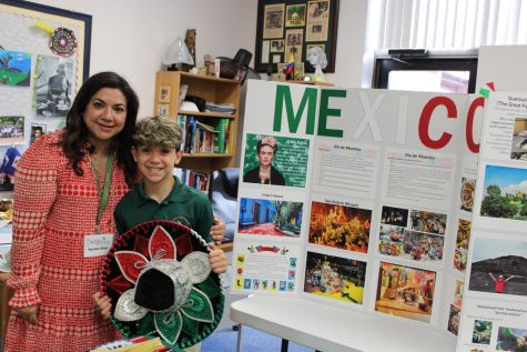 A family from Mexico poses with a poster and shares their cultural story.