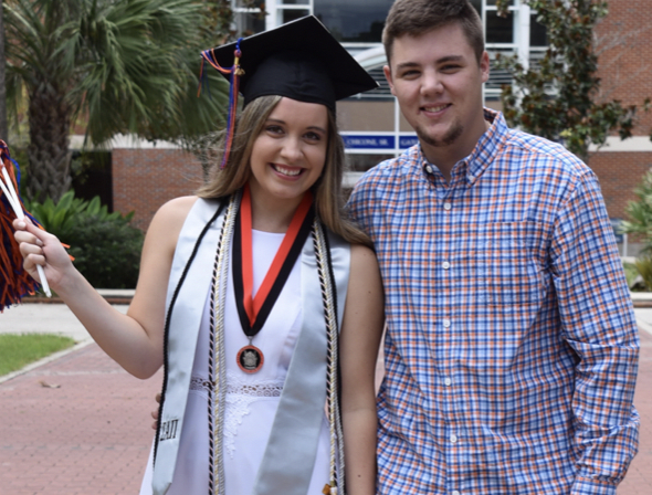Ms. Fleming poses after her college graduation from UF in 2019.