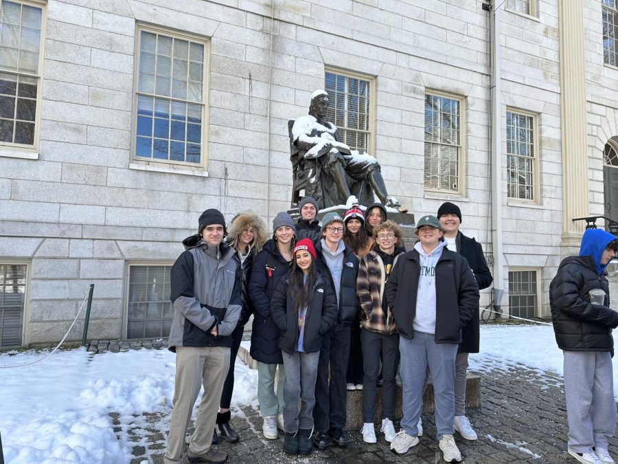 The Model Congress team posing in front of the famous John Harvard statue.