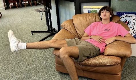 This photo shows a student relaxing in what could be the most comfortable chair  on campus.