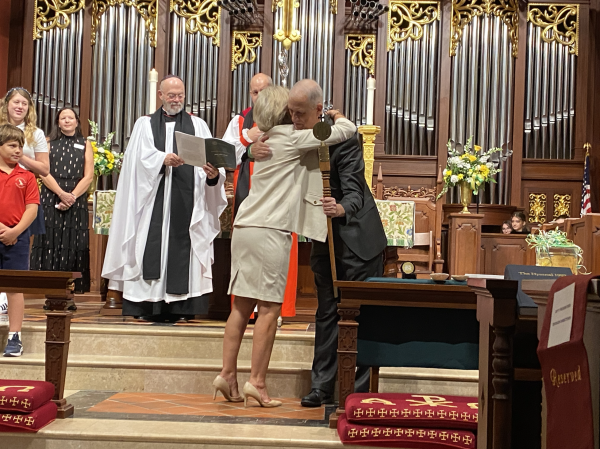 New Head of School Mr. Kraft embracing retired Dr. Jan Pullen during the service.