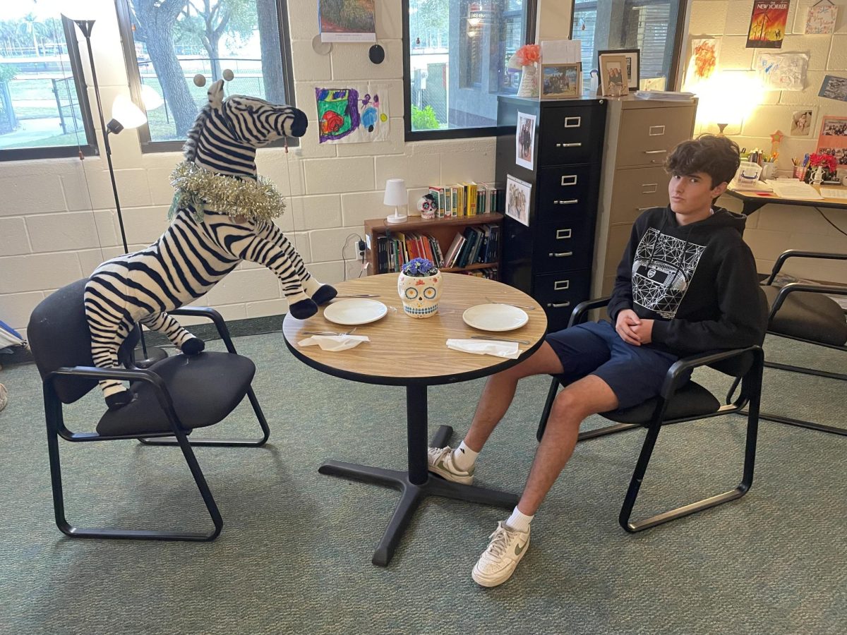 Staff Writer Jackson Pakbaz has a formal discussion at dinner with his date, a stuffed zebra