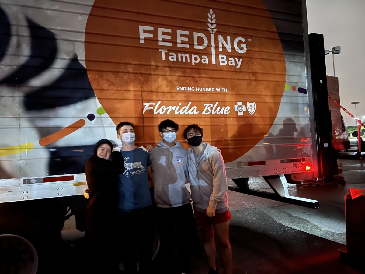 Senior Alex McLemore serves during the holiday for Feeding America