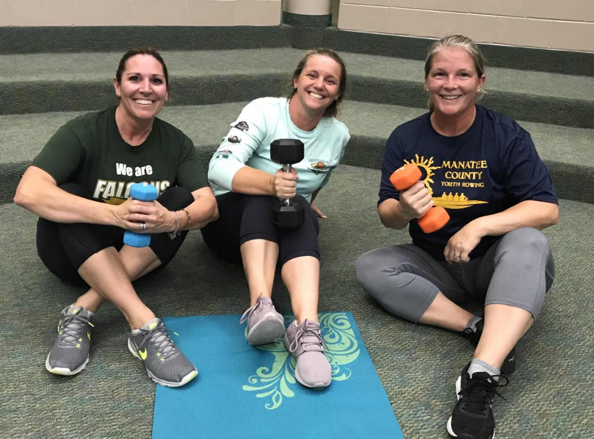 Faculty members Stephanie Ham, Heather Millican, and Kate Sinphay pose for a picture after finishing weight training in the upper school commons. (Photo by Anna Conn)