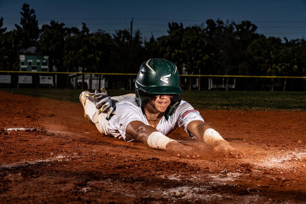 Sophomore Gabe Conn sliding into home plate. Photo by Rocktown Media