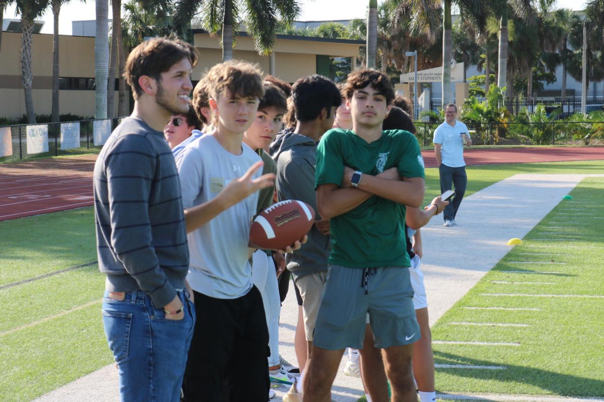 The sophomores chill on the sideline as their team competes. 