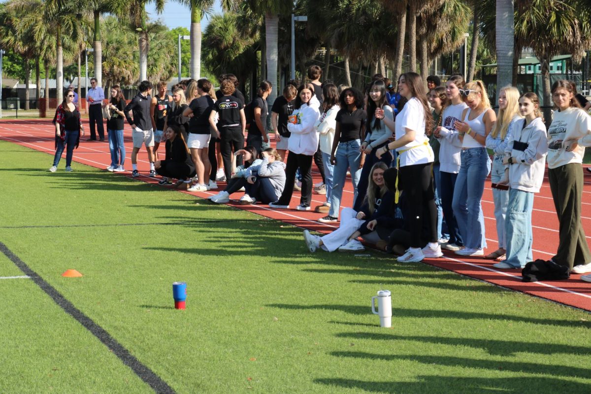 The senior grade lines up to watch their team win in the final. 