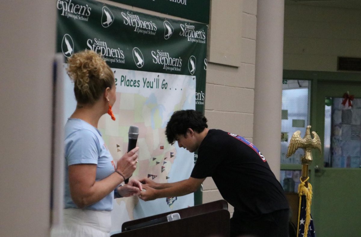 Editor in Chief of the Gauntlet, Andrei Black, places his pin on Southern Methodist University. 