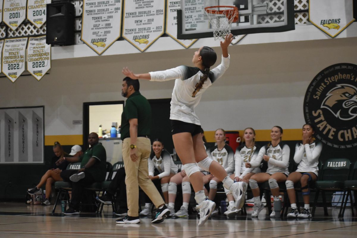 Senior captain Sophia Ierulli extends to jump-serve. 
