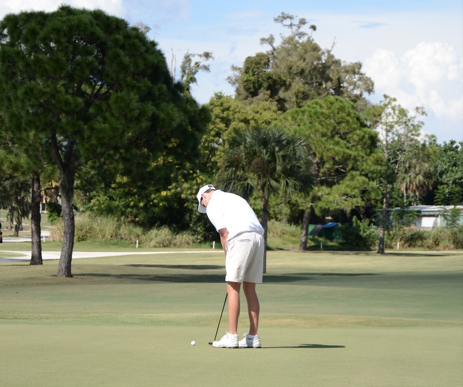 Fergus McLeod tees it up, putting the ball into the hole.