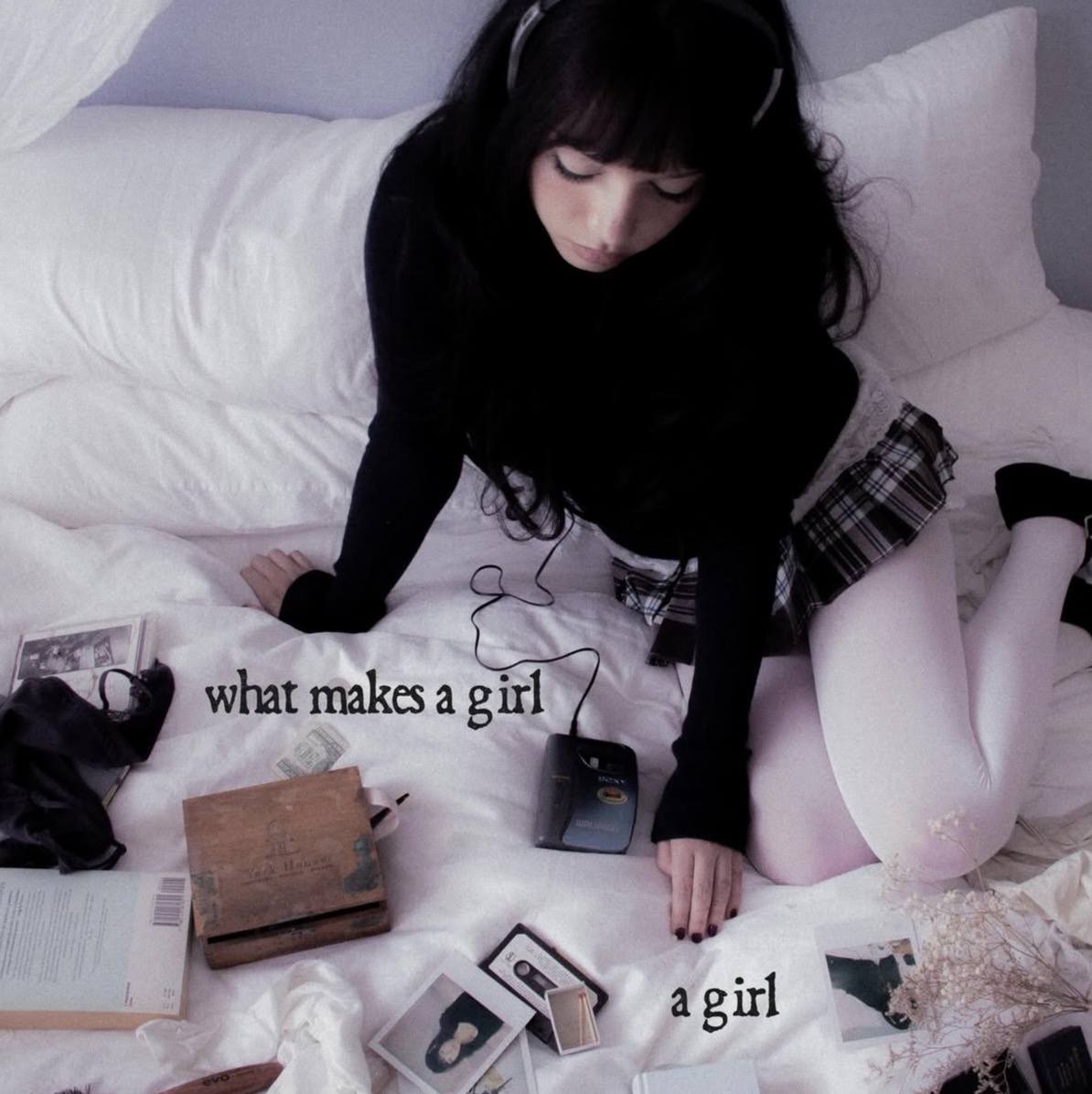 Esha Tewari's What Makes a Girl a Girl album cover features her as the embodiment of a Pinterest girl's teenage dream: soft colors, snug tights, and vintage polaroids scattered around her flush covers. Album cover licensed to Atlantic Records